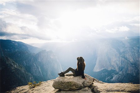 simsearch:614-05557077,k - Young woman sitting at top of mountain, overlooking Yosemite National Park, California, USA Stock Photo - Premium Royalty-Free, Code: 614-08826695