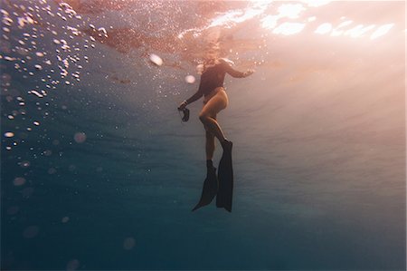 flipper (footwear) - Woman treading water near surface of sea Stock Photo - Premium Royalty-Free, Code: 614-08826747