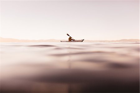 Woman kayaking on Lake Tahoe, California, USA Stock Photo - Premium Royalty-Free, Code: 614-08826806