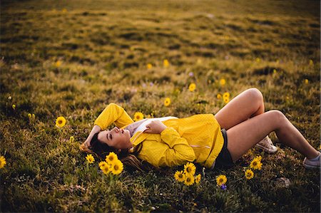 simsearch:649-09078617,k - Woman lying on grass in flower filled meadow, Rocky Mountain National Park, Colorado, USA Stock Photo - Premium Royalty-Free, Code: 614-08826825