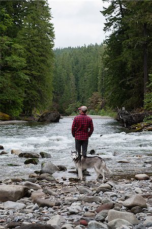 simsearch:614-05557077,k - Rear view of man with dog on riverbank looking away, Packwood, Washington, USA Stock Photo - Premium Royalty-Free, Code: 614-08827010