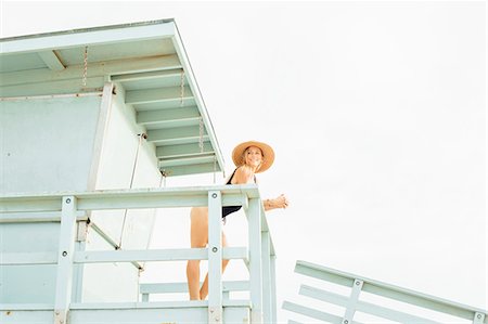simsearch:614-06896619,k - Woman wearing swimsuit on lifeguard tower looking away Foto de stock - Sin royalties Premium, Código: 614-08827378