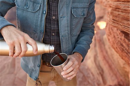 simsearch:614-09078761,k - Man pouring hot drink from drinking flask, mid section, Page, Arizona, USA Stock Photo - Premium Royalty-Free, Code: 614-08827391