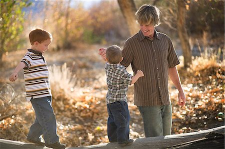 simsearch:649-07437107,k - Father playing with young sons on log Stock Photo - Premium Royalty-Free, Code: 614-08865948