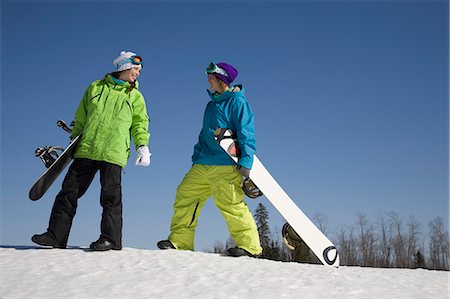 Two Women Carrying Snowboards Stock Photo - Premium Royalty-Free, Code: 614-08866395