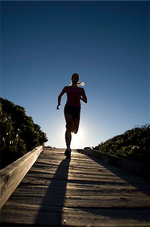 simsearch:628-05817723,k - Young Woman Running down BoardWalk Stock Photo - Premium Royalty-Free, Code: 614-08866517