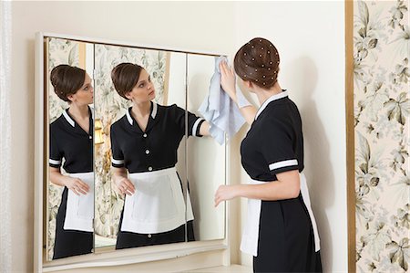 room maid cleaning mirror Stock Photo - Premium Royalty-Free, Code: 614-08866583
