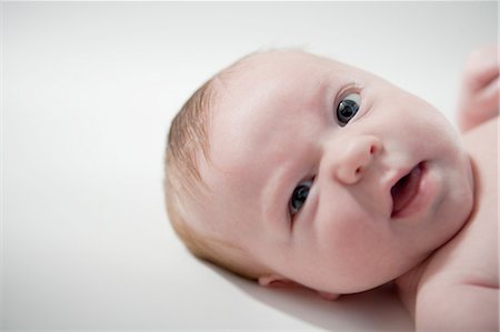 simsearch:632-03027302,k - Young baby laying down, making face Stock Photo - Premium Royalty-Free, Code: 614-08866926