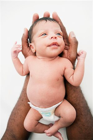 simsearch:632-08001820,k - Father holding young baby in arms Stock Photo - Premium Royalty-Free, Code: 614-08866931