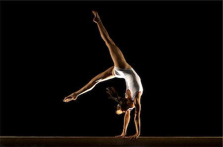 simsearch:858-03799642,k - gymnast doing hand stand on beam Stock Photo - Premium Royalty-Free, Code: 614-08867159