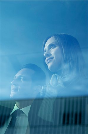 simsearch:614-08392638,k - Businessman and woman looking out window Stock Photo - Premium Royalty-Free, Code: 614-08867322