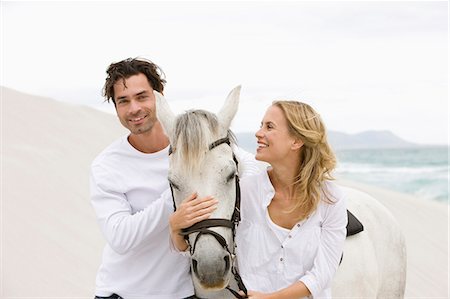 simsearch:6113-06720867,k - Couple with horse on the beach Stock Photo - Premium Royalty-Free, Code: 614-08867428