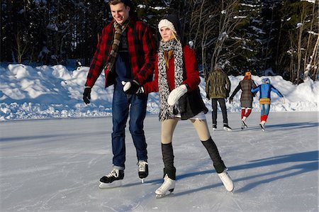 Teenagers ice-skating outdoors Stock Photo - Premium Royalty-Free, Code: 614-08867564