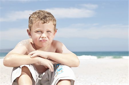 sad african children - Boy sitting on beach Stock Photo - Premium Royalty-Free, Code: 614-08867747
