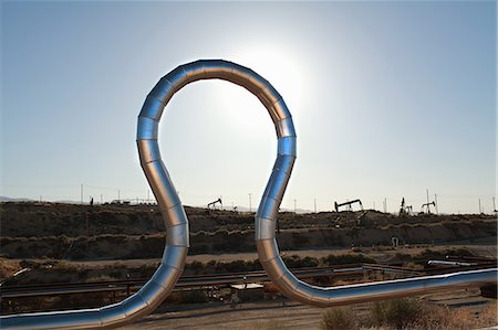 pipeline, blue sky - Curved pipe at oil field Stock Photo - Premium Royalty-Free, Code: 614-08867895