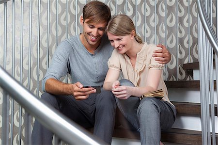 simsearch:6108-05873097,k - Couple reading together on steps Stock Photo - Premium Royalty-Free, Code: 614-08868093