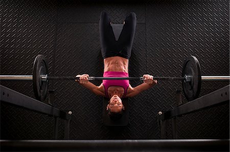 Woman lifting weights in gym Stock Photo - Premium Royalty-Free, Code: 614-08868395