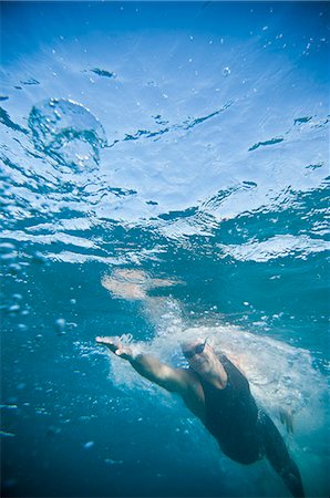 Swimmer training in ocean Stock Photo - Premium Royalty-Free, Code: 614-08868478