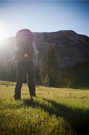 simsearch:649-08086253,k - Hiker carrying pack on grassy hillside Stock Photo - Premium Royalty-Free, Code: 614-08868540