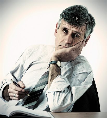 simsearch:649-07119200,k - Businessman resting head in hand at desk Stock Photo - Premium Royalty-Free, Code: 614-08868944
