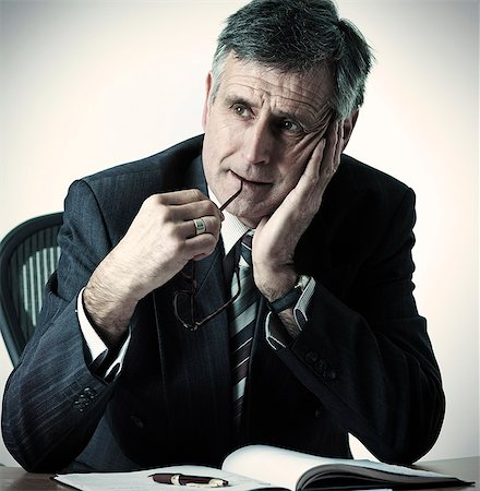 simsearch:649-07119200,k - Businessman resting head in hand at desk Stock Photo - Premium Royalty-Free, Code: 614-08868942