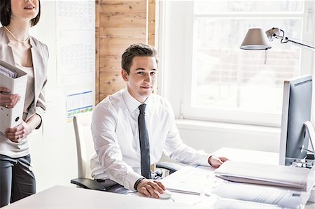 simsearch:700-03720180,k - Businessman sitting at desk in office Stock Photo - Premium Royalty-Free, Code: 614-08869348