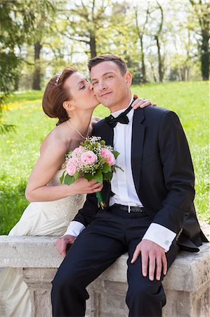 simsearch:649-06432557,k - Newlywed couple kissing on wall Stock Photo - Premium Royalty-Free, Code: 614-08869417