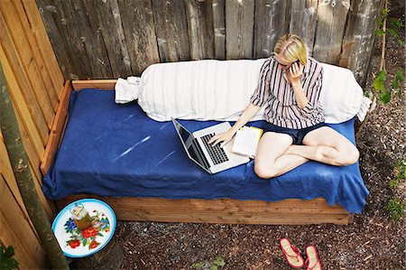 simsearch:695-05771662,k - Woman using laptop on sofa outdoors Stock Photo - Premium Royalty-Free, Code: 614-08869660