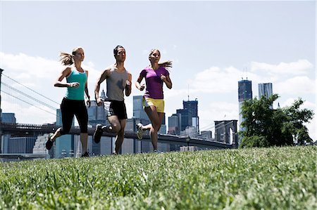 Three people jogging in park Stock Photo - Premium Royalty-Free, Code: 614-08874125