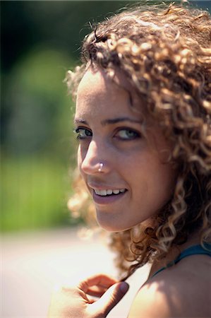 simsearch:400-04435419,k - Woman with curly hair and nose ring, close up Stock Photo - Premium Royalty-Free, Code: 614-08874122