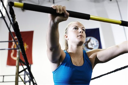 simsearch:640-06050736,k - Woman working out in gym with exercise bar and resistance cord Stock Photo - Premium Royalty-Free, Code: 614-08874249