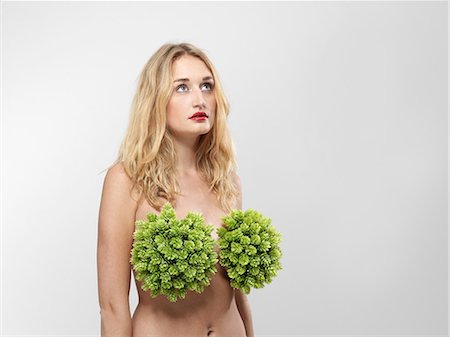 Woman with plants covering breasts Stock Photo - Premium Royalty-Free, Code: 614-08874762