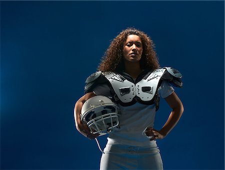 Portrait of female american football player with shoulder pads and helmet Photographie de stock - Premium Libres de Droits, Code: 614-08874994