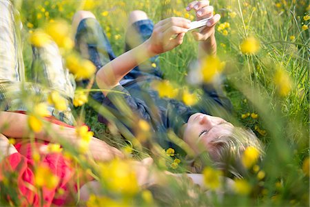 simsearch:649-06845253,k - Boys lying in long grass playing on smartphone Stock Photo - Premium Royalty-Free, Code: 614-08875441