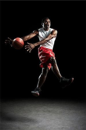 Young male basketball player throwing ball Stock Photo - Premium Royalty-Free, Code: 614-08875664