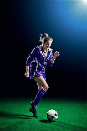 simsearch:614-07239995,k - Female soccer player running with ball Stock Photo - Premium Royalty-Free, Code: 614-08875685
