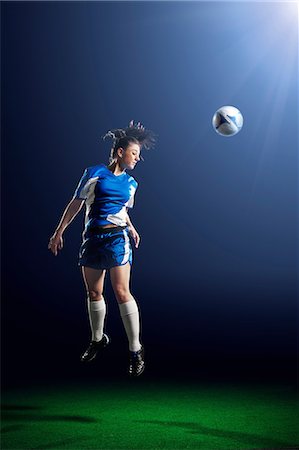 simsearch:614-07239995,k - Young female soccer player heading ball Stock Photo - Premium Royalty-Free, Code: 614-08875688