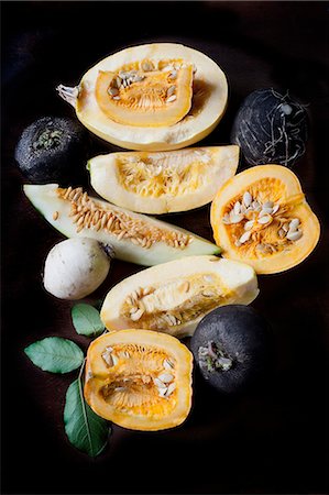 pumpkin fruit and his leafs - Still life of sliced pumpkin and melon with black turnips Stock Photo - Premium Royalty-Free, Code: 614-08876918