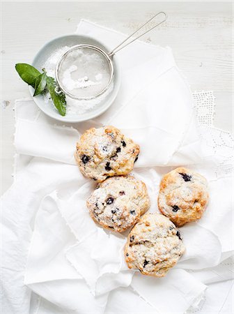 simsearch:614-06537664,k - Still life of blueberry scones served with caster sugar Stock Photo - Premium Royalty-Free, Code: 614-08877114