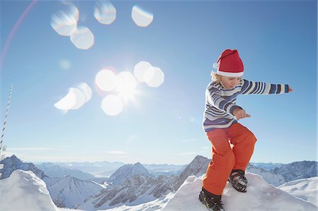simsearch:614-06896861,k - Young boy standing on pile of snow, in snowy landscape Stock Photo - Premium Royalty-Free, Code: 614-08877226