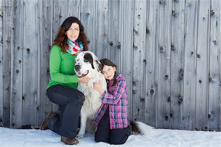 dog on woman - Mother and daughter with their pet dog Stock Photo - Premium Royalty-Free, Code: 614-08877267