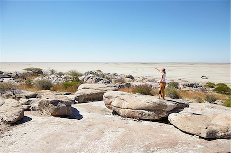 Mother and son on rock, Kubu Island, Makgadikgadi Pan, Botswana, Africa Stock Photo - Premium Royalty-Free, Code: 614-08877443