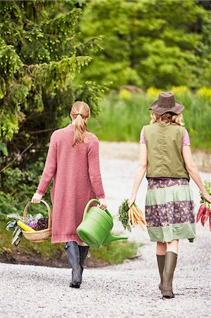 Rear view of two women carrying vegetables Stock Photo - Premium Royalty-Free, Code: 614-08877749