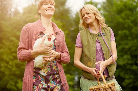 simsearch:649-07560533,k - Two women in field carrying hen and basket Photographie de stock - Premium Libres de Droits, Code: 614-08877760