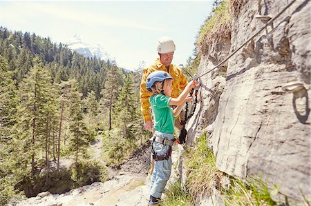 Father and child rock climbing, Ehrwald, Tyrol, Austria Stock Photo - Premium Royalty-Free, Code: 614-08877948