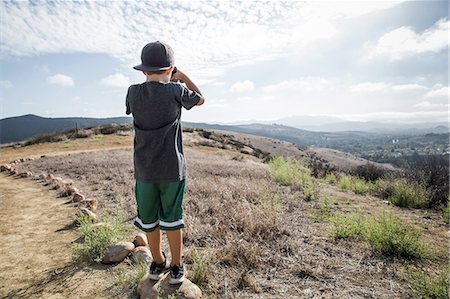 stand - Rear view of boy looking through binoculars from footpath stone, Thousand Oaks, California USA Stock Photo - Premium Royalty-Free, Code: 614-08878862