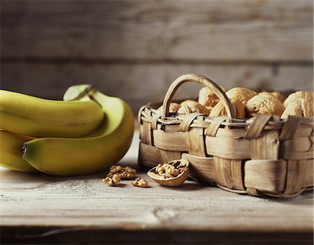 simsearch:614-01088098,k - Organic bakery ingredients, wicker basket of walnuts and bunch of bananas Stock Photo - Premium Royalty-Free, Code: 614-08879064
