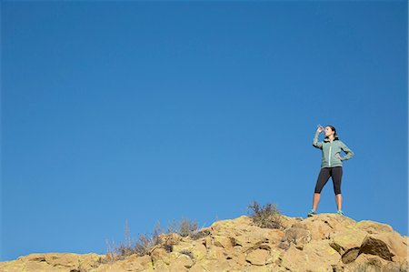 simsearch:614-09078761,k - Female runner drinking from water bottle on rugged hill Stock Photo - Premium Royalty-Free, Code: 614-08879155