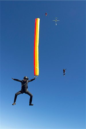 Woman skydiving with parachute Stock Photo - Premium Royalty-Free, Code: 614-08870337