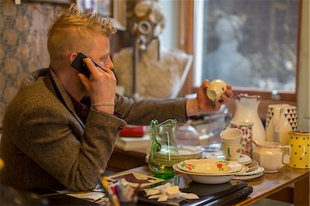 simsearch:649-07119141,k - Man talking on cell phone at table Stock Photo - Premium Royalty-Free, Code: 614-08870496